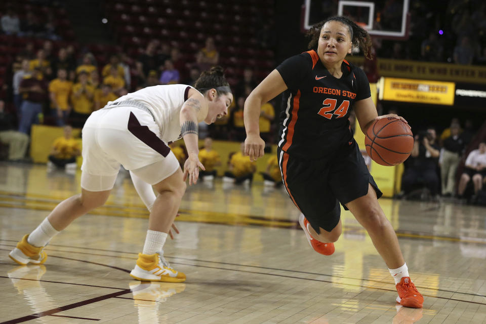 Oregon State's Destiny Slocum (24) drives to the basket after faking out Arizona State's Robbi Ryan during the first half of an NCAA college basketball game Sunday, Jan. 12, 2020, in Tempe, Ariz. (AP Photo/Darryl Webb)