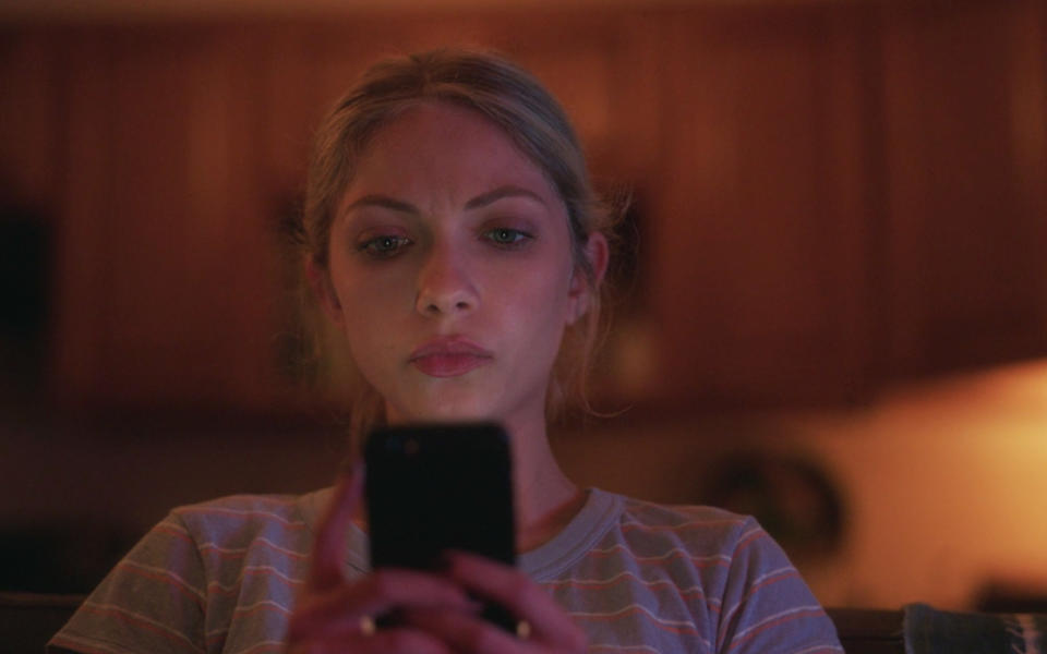 a woman looking at her phone screen