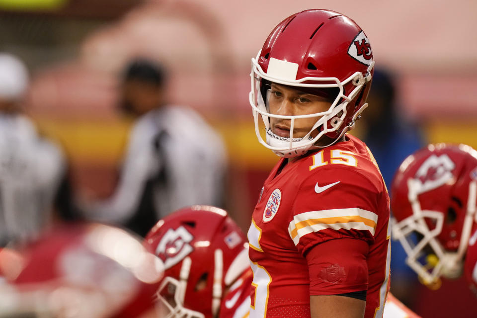 Kansas City Chiefs quarterback Patrick Mahomes behind center looks back.