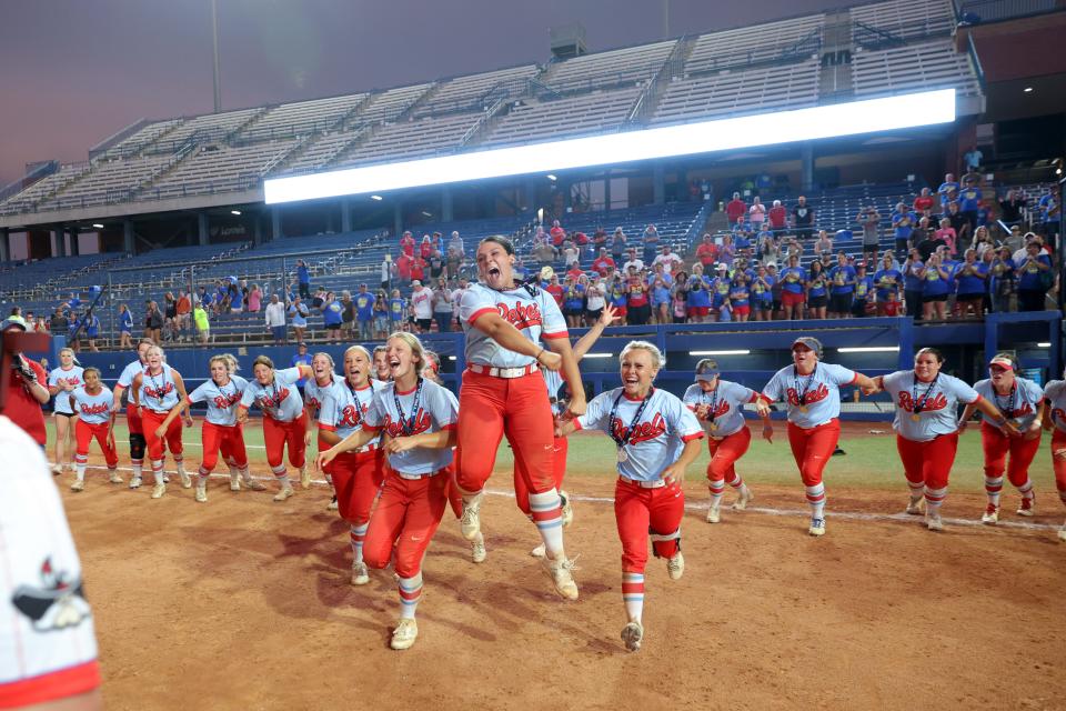 Silo players run to collect their trophy after the Class 4A slowpitch softball championship game between Dale and Silo at USA Hall of Fame Stadium in Oklahoma City, Tuesday, April 30, 2024.