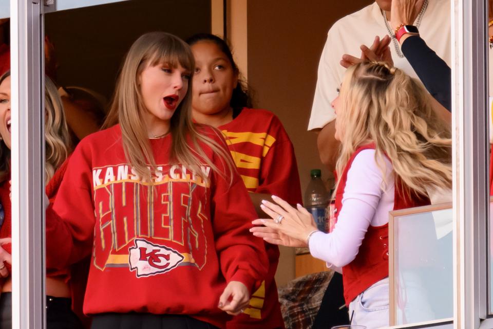 Taylor Swift, wearing a Kansas City Chief’s shirt, and Brittany Mahomes react to a Travis Kelce touchdown in Kansas City.