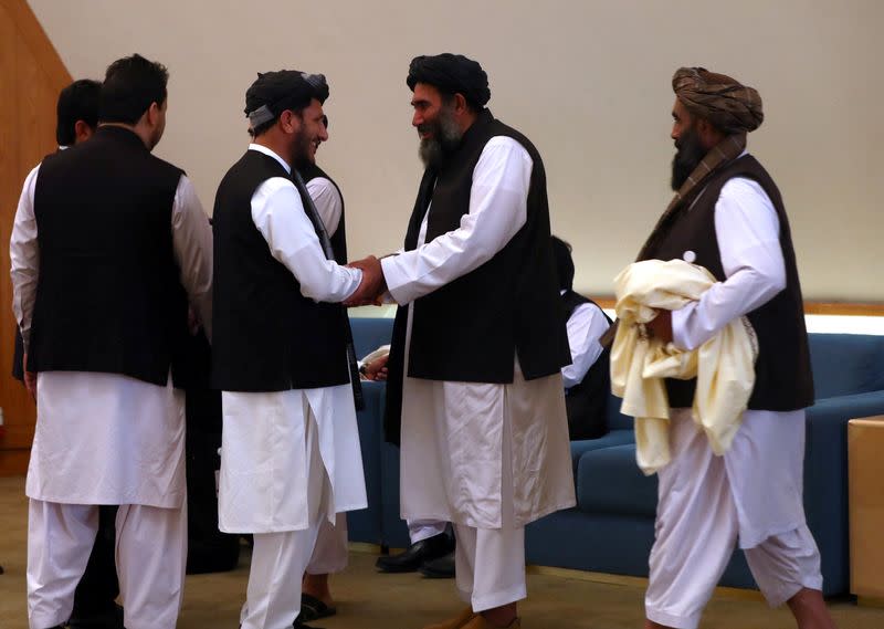 Members of Afghanistan's Taliban delegation gather ahead of an agreement signing between them and U.S. officials in Doha