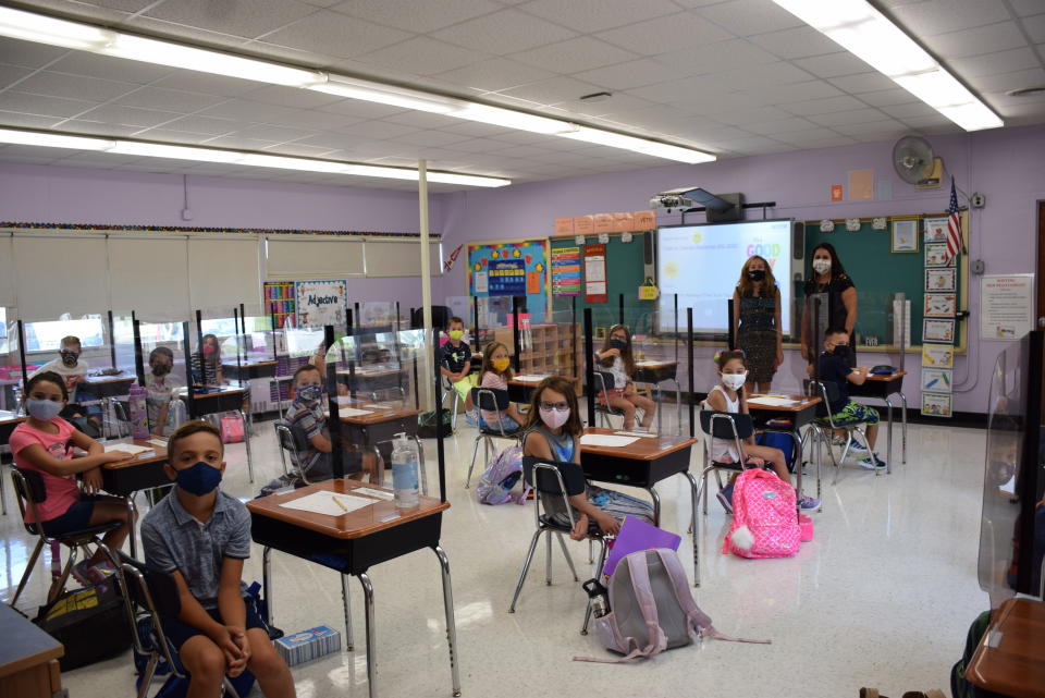 Mandalay Elementary School teacher, left, Stacy Wright, is pictured with Principal Marie Pisicchio and her third grade class on opening day in Wantagh. (Courtesy of Wantagh School District.)