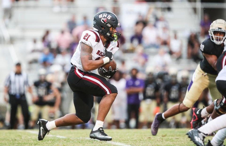 Ballard's Journey Wyche runs for yardage in the first quarter against Male on Aug. 25, 2023.