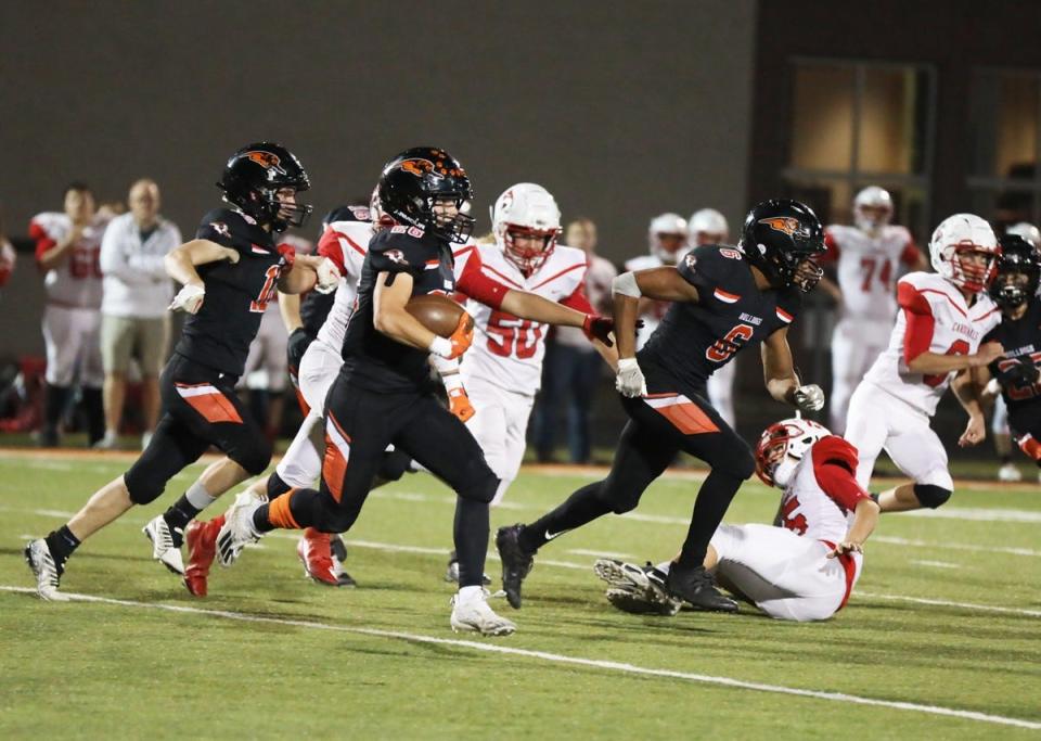 Mediapolis’ Braxton Davis uses the blocking of Anthony Isley on a kickoff return in third quarter action in their Class 1A playoff game.