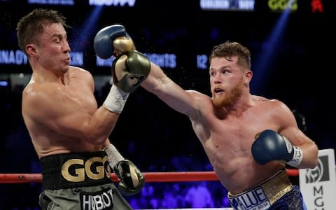 Canelo Alvarez, right, throws a right at Gennady Golovkin - Credit: AP