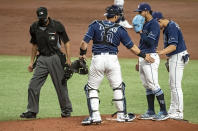 Home plate umpire Gabe Morales, left breaks up a meeting on the mound between Tampa Bay Rays' Mike Zunino (10), Luis Patino and Willy Adames, right, during the third inning of a baseball game against the New York Yankees Tuesday, May 11, 2021, in St. Petersburg, Fla. (AP Photo/Steve Nesius)