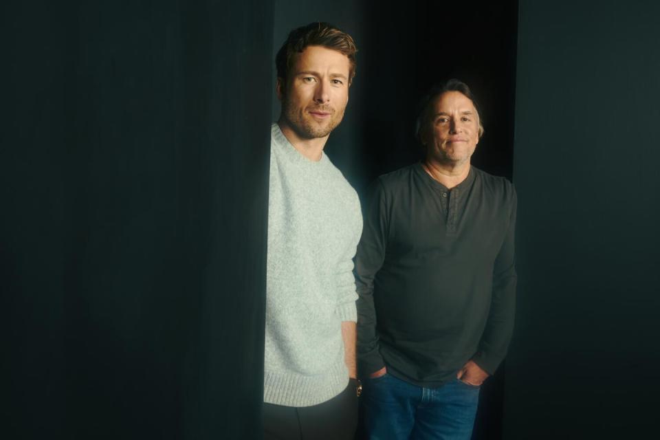 Two men pose for a portrait.