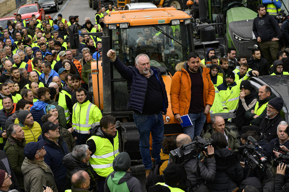 Farmers with their tractors attend a protest in Pamplona, northern Spain, Friday, Feb. 9, 2024. For fourth non stop days, farmers in Spain have staged tractor protests across the country, blocking highways and causing traffic jams to demand of changes in EU policies and funds and measures to combat production cost hikes. (AP Photo/Alvaro Barrientos)