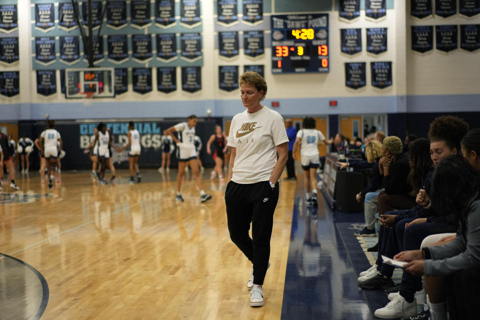 Centennial High School girls basketball coach Karen Weitz stands walks on the court during a break in play in a girls high school basketball game, Tuesday, Jan. 24, 2023, in Las Vegas. Weitz coaches both the boys and girls basketball teams at the school. (AP Photo/John Locher)