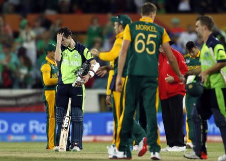 Ireland's George Dockrell (L) reacts after being bowled for 25 runs by South Africa's Morne Morkel to end their Cricket World Cup match at Manuka Oval in Canberra March 3, 2015. REUTERS/Jason Reed