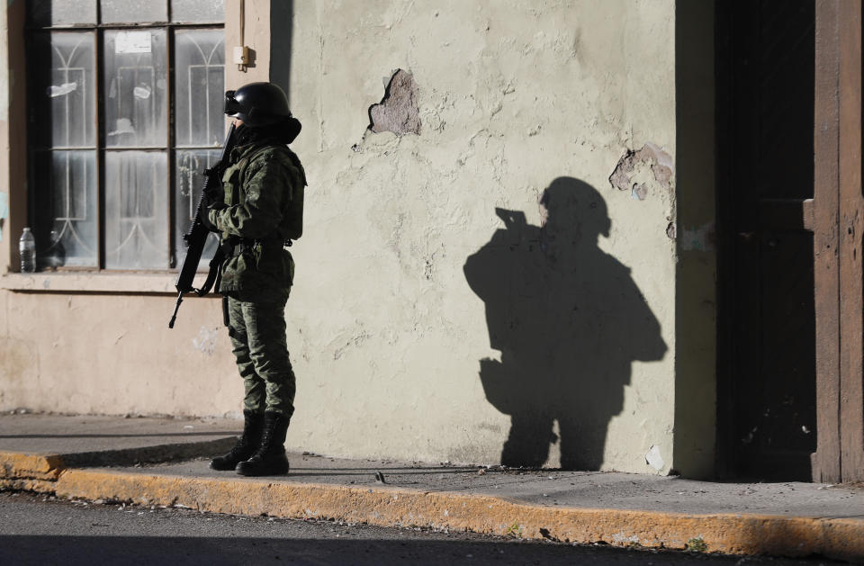 A member of the Mexican security forces stands guard near City Hall in Villa Union, Mexico, Tuesday, Dec. 3, 2019. Some long for the days when Mexican marines successfully patrolled the area until President Andres Manuel Lopez Obrador reassigned them to other duties. They were known for not getting corrupted by the cartels and not yielding in battle with them. “The marines are the only ones I trust,” said one local mechanic. “The rest are going to take a bribe.” (AP Photo/Eduardo Verdugo)