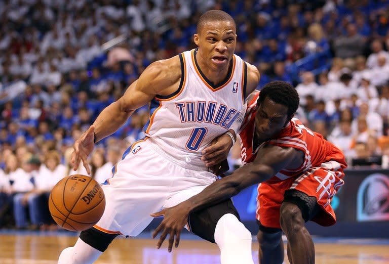 Russell Westbrook (L) of the Oklahoma City Thunder is guarded by Patrick Beverley of the Houston Rockets during their game on April 24, 2013. Westbrook scored 29 points to lead the Thunder over Houston 105-102 for a 2-0 lead in their first-round NBA playoff series
