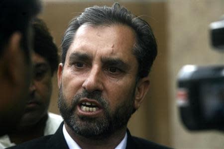 Samiullah Afridi, lawyer for Shakil Afridi who ran a fake vaccination campaign to try help U.S. officials find al-Qaeda chief Osama bin laden, speaks to the media after appearing before the court in Peshawar October 30, 2013. REUTERS/Khuram Parvez
