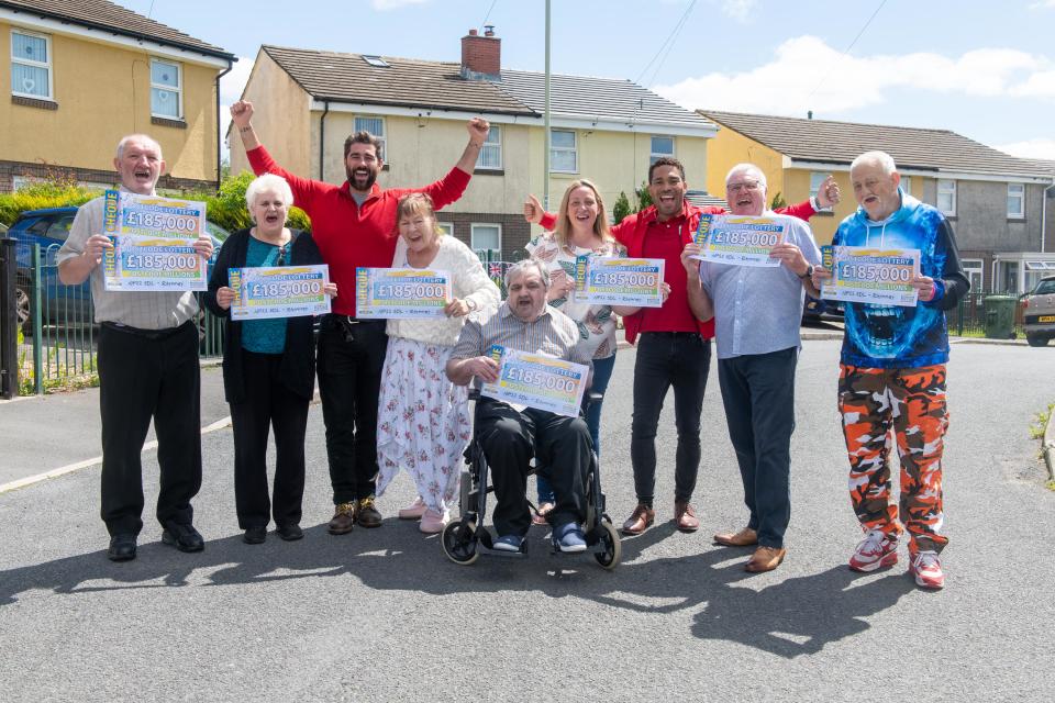 winners holding their cheques.