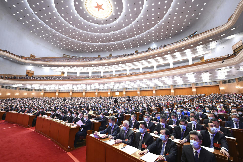 In this photo released by China's Xinhua News Agency, delegates attend the closing session of China's National People's Congress (NPC) at the Great Hall of the People in Beijing, Friday, March 11, 2022. (Shen Hong/Xinhua via AP)
