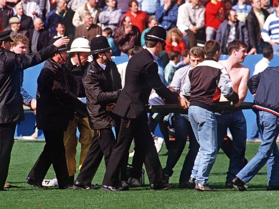 An injured Liverpool fan at Hillsborough stadium (AFP/Getty)