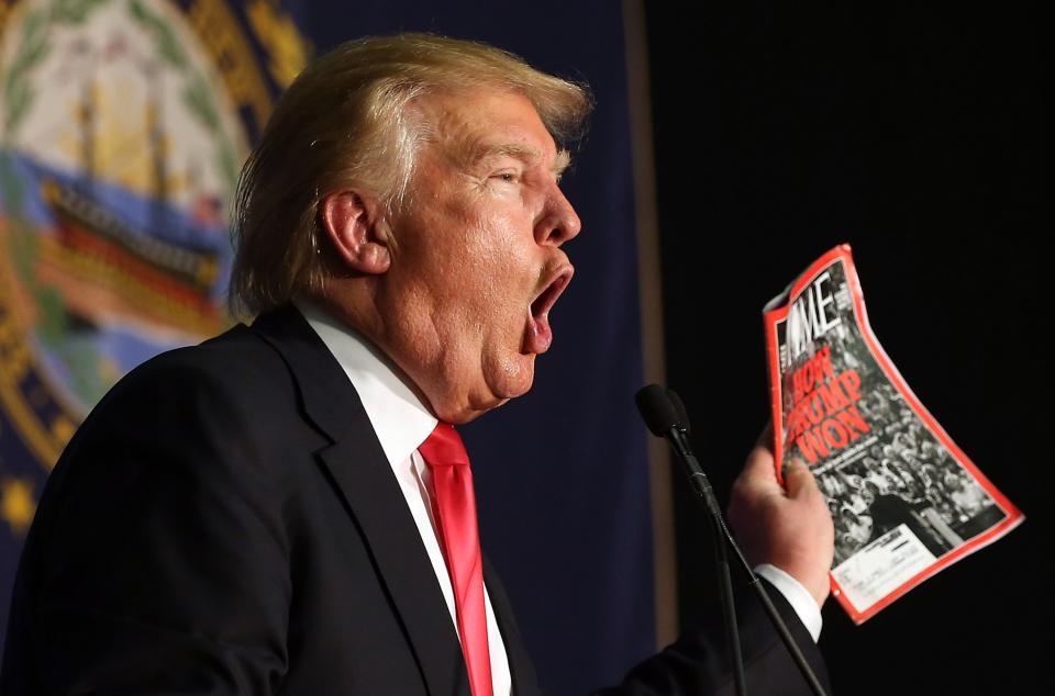 Donald Trump holds up a TIME magazine in Feb. 2016 at a rally in New Hampshire (Getty)