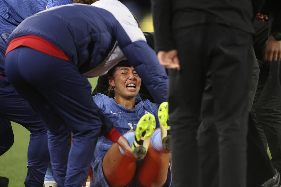 France's Selma Bacha grimaces as she is lifted onto a stretch after an injury during their friendly soccer match against Australia ahead of the Women's World Cup in Melbourne, Friday, July 14, 2023. (AP Photo/Hamish Blair)