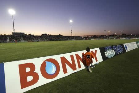 A youngster watches a soccer match between host team Sacramento Republic FC and Charleston Battery at Bonney Field, the team's home pitch, in Sacramento, California August 27, 2014. REUTERS/Robert Galbraith