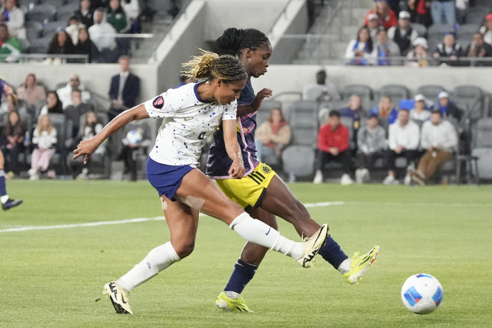 United States forward Midge Purce, left, takes a shot on goal during the second half of a CONCACAF Gold Cup women's soccer tournament quarterfinal against Colombia, Sunday, March 3, 2024, in Los Angeles. (AP Photo/Marcio Jose Sanchez)