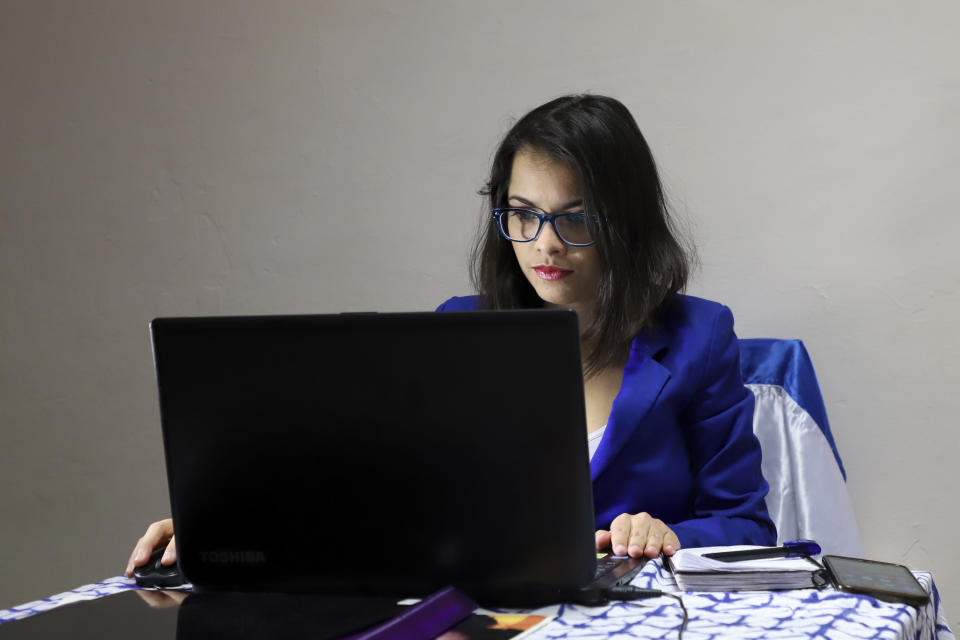 In this Jan. 8, 2019 photo, 28-year-old lawyer Francys Valdivia Machado, president of the Madres de Abril Association, joins a scheduled videoconference with other members of the group's executive committee, in an undisclosed location in Mexico where she is in hiding. Her laptop open on a small table and Nicaragua's flag draped over the back of her wooden chair, the 28-year-old lawyer discussed creating a virtual museum of memory to document the repression and opening a savings account for the group. (AP Photo)