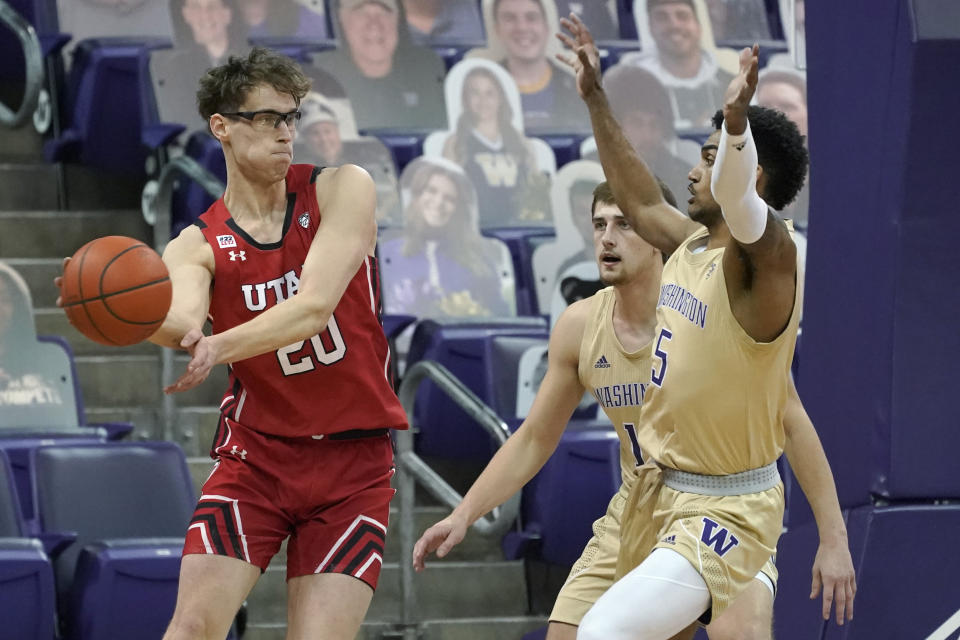 Utah forward Mikael Jantunen, left, passes around Washington guard Jamal Bey (5) during the first half of an NCAA college basketball game, Sunday, Jan. 24, 2021, in Seattle. (AP Photo/Ted S. Warren)