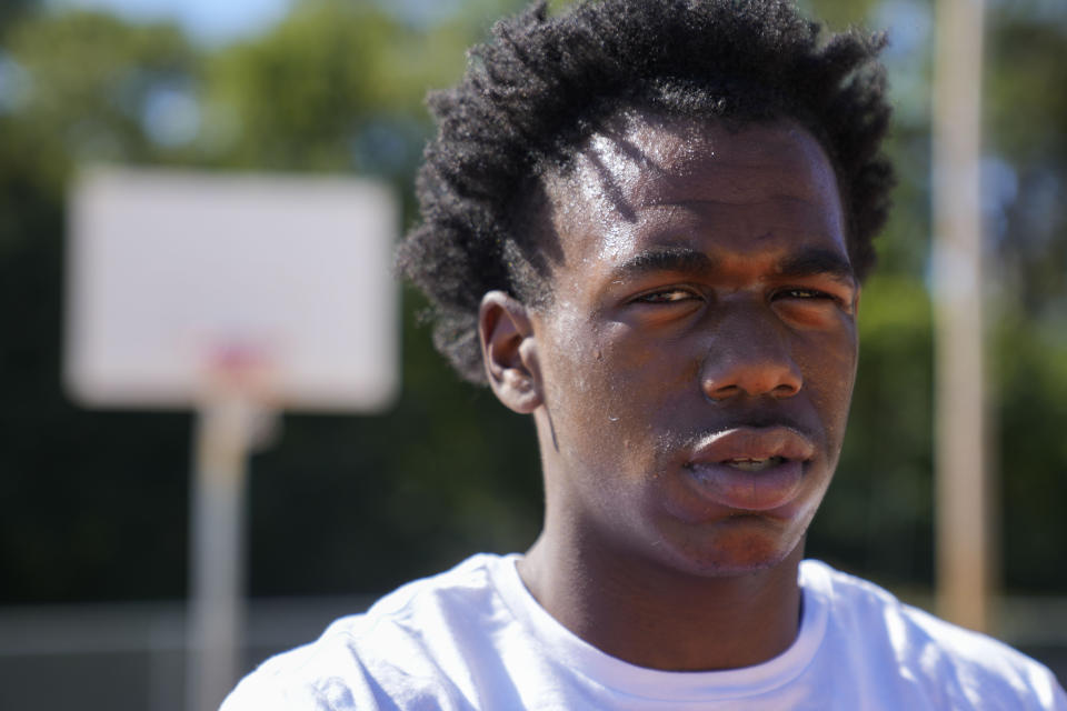 Bryant West poses for a portrait on a basketball court built by NBA star Devin Booker, who went to high school here, in Moss Point, Miss., Friday, Oct. 20, 2023. Girls consistently are outperforming boys, graduating at higher rates at public high schools around the country. Students, educators and researchers say there are several reasons why boys are falling short.(AP Photo/Gerald Herbert)