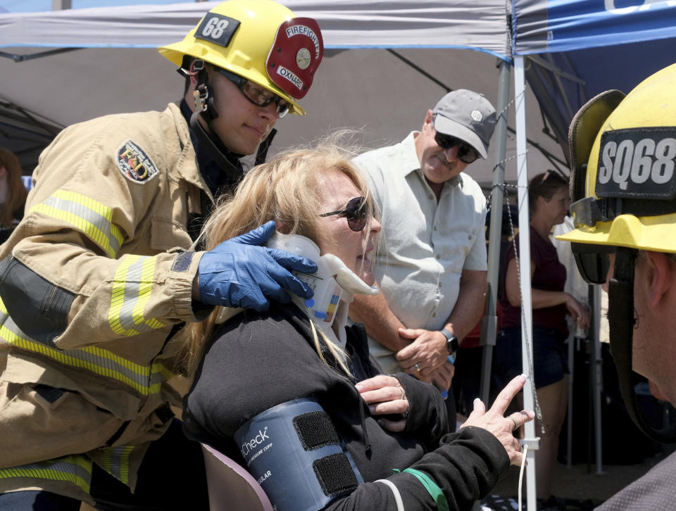 Trish Montanari, 60, from Florida, receives medical attention after their Amtrak train derailed in Moorpark, Calif., on Wednesday, June 28, 2023. Montanari was on vacation traveling with other family members from Los Angeles to Seattle. Authorities say an Amtrak passenger train carrying 190 passengers derailed after striking a vehicle on tracks in Southern California. Only minor injuries were reported. (Dean Musgrove/The Orange County Register via AP)