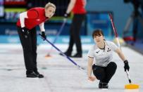 Curling - Pyeongchang 2018 Winter Olympics - Women's Bronze Medal Match - Britain v Japan - Gangneung Curling Center - Gangneung, South Korea - February 24, 2018 - Second Yumi Suzuki of Japan and second Vicki Adams of Britain watch the shot. REUTERS/John Sibley