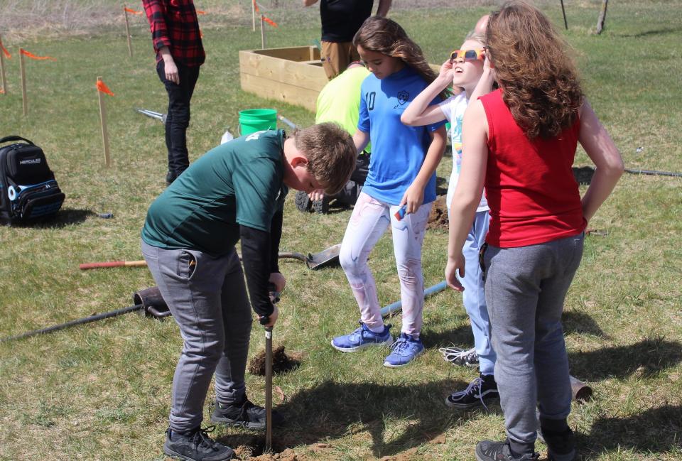 A group of students from Woodbridge Elementary help with installation of a well at the school on Monday, April 8, 2024.