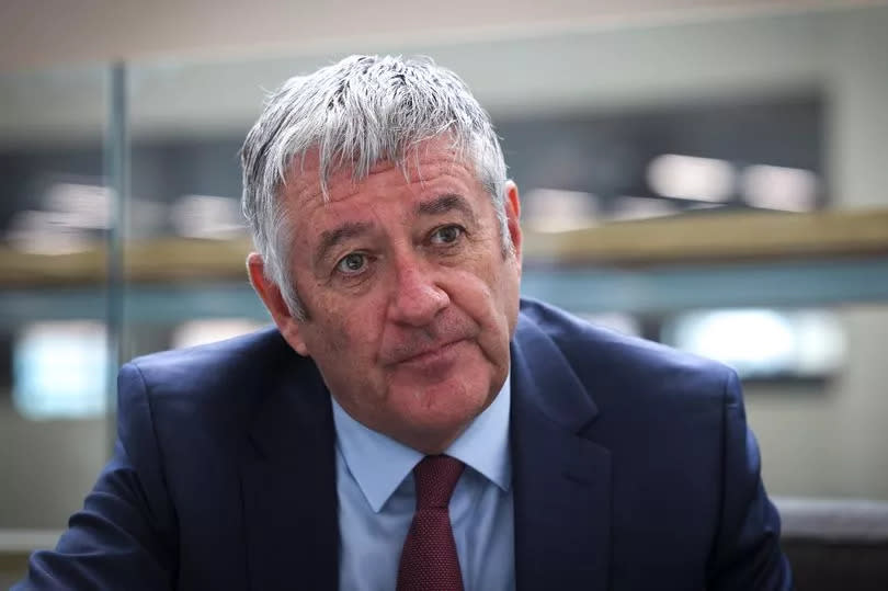 Lead commissioner Tony McArdle pictured at Nottingham City Council's Loxley House, sat down wearing a dark blue suit jacket, light blue shirt and red tie.