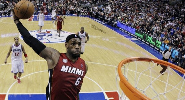 Quick Hits Basketball (FILE - In this March 13, 2013, file photo, Miami Heat's LeBron James goes up for a dunk in the first half