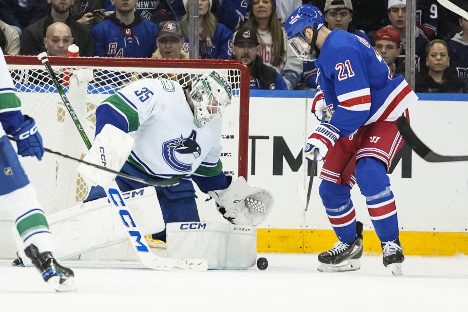 New York Rangers' Barclay Goodrow (21) watches as Vancouver Canucks goaltender Thatcher Demko (35) stops a shot on goal during the third period of an NHL hockey game Monday, Jan. 8, 2024, in New York. (AP Photo/Frank Franklin II)