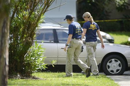 FBI personnel walk through the complex surrounding the apartment, where Ibragim Todashev, 27, was shot and killed by FBI, in Orlando, Florida, May 22, 2013. REUTERS/Phelan M. Ebenhack