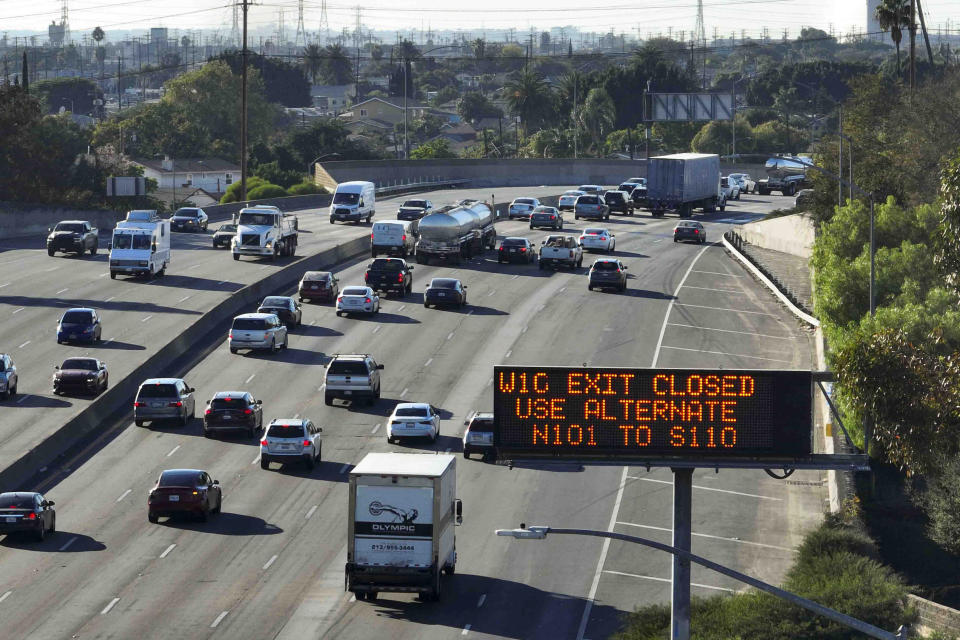 A detour information sign stands along Interstate 5 while a section of Interstate 10 remains closed due to a recent fire in Los Angeles, Tuesday, Nov. 14, 2023. It will take at least three weeks to repair the freeway damaged in an arson fire, the California governor said Tuesday, leaving the city already accustomed to soul-crushing traffic without part of a vital artery that serves hundreds of thousands of people daily. (AP Photo/Jae C. Hong)