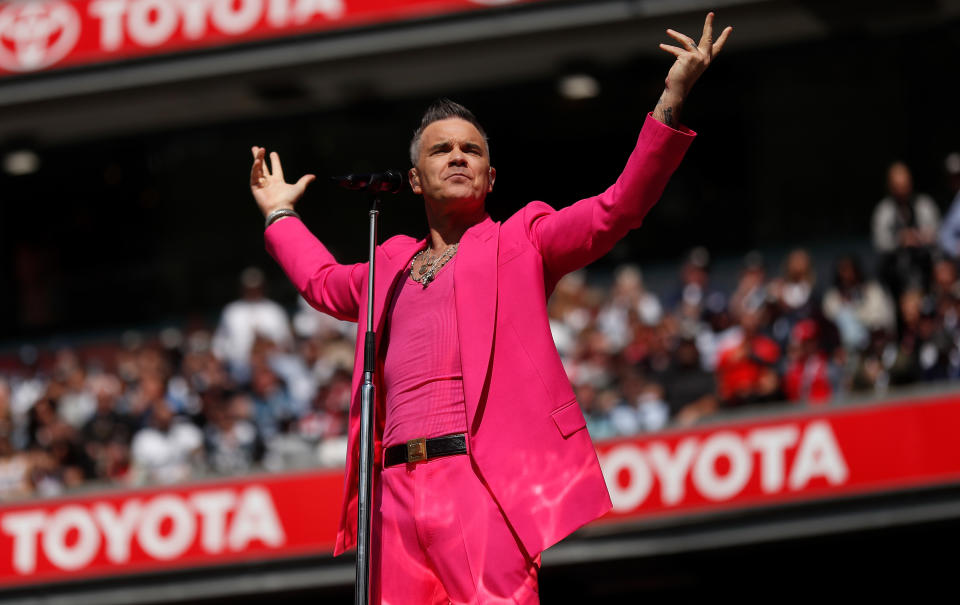 MELBOURNE, AUSTRALIA - SEPTEMBER 24: Robbie Williams performs during the 2022 Toyota AFL Grand Final match between the Geelong Cats and the Sydney Swans at the Melbourne Cricket Ground on September 24, 2022 in Melbourne, Australia. (Photo by Michael Willson/AFL Photos via Getty Images)