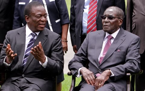 Emmerson Mnangagwa, then vice president, and Robert Mugabe, then president, in 2014 - Credit: Tsvangirayi Mukwazhi/AP