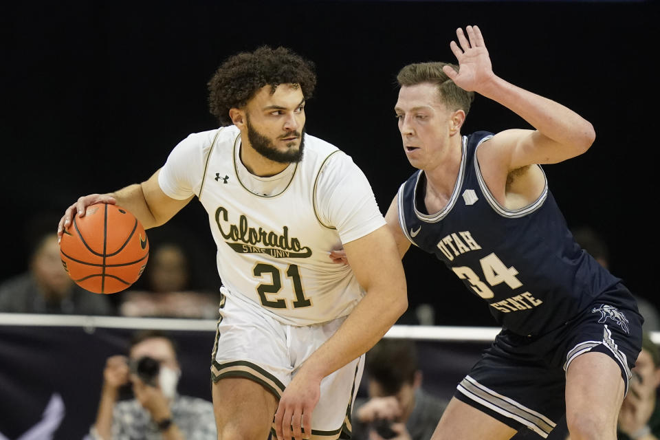 Utah State forward Justin Bean (34) guards against Colorado State guard David Roddy (21) during the first half of an NCAA college basketball game in the quarterfinals of Mountain West Conference men's tournament Thursday, March 10, 2022, in Las Vegas. (AP Photo/Rick Bowmer)