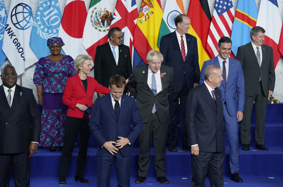 European Commission President Ursula von der Leyen, third left, speaks with British Prime Minister Boris Johnson, center, during a group photo at the G20 summit in Rome, Saturday, Oct. 30, 2021. The two-day Group of 20 summit is the first in-person gathering of leaders of the world's biggest economies since the COVID-19 pandemic started. (AP Photo/Evan Vucci, Pool)