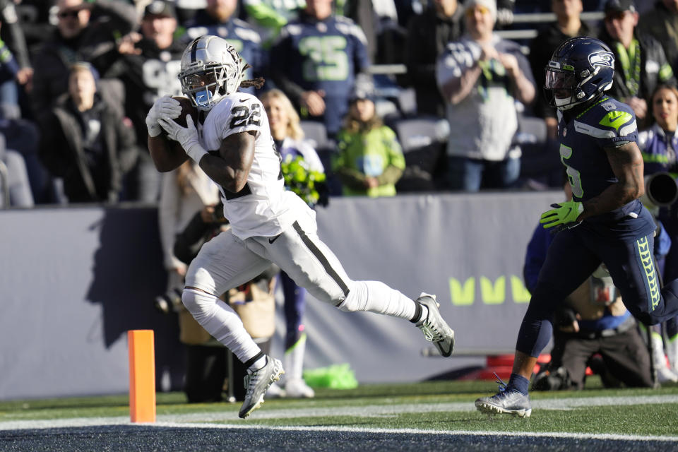 Las Vegas Raiders running back Ameer Abdullah (22) catches a touchdown pass past Seattle Seahawks safety Quandre Diggs (6) during the first half of an NFL football game Sunday, Nov. 27, 2022, in Seattle. (AP Photo/Gregory Bull)