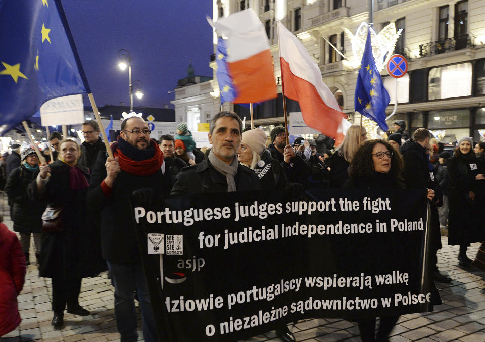 Judges and lawyers from across Europe, many of them dressed in their judicial robes, march silently in Warsaw, Poland, Saturday, Jan. 11, 2020. The rally was a show of solidarity with Polish judges, who are protesting a bill that would allow the government to fire judges whose rulings they don't like. The legislation has been denounced by the European Union and the United Nations. (AP Photo/Czarek Sokolowski)