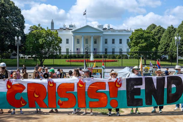 PHOTO: Climate activists hold a banner demanding President Biden act on climate change near the White House on July 4, 2023 in Washington, D.C. (Tasos Katopodis/Getty Images)