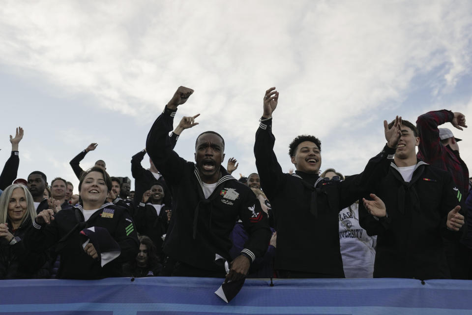 Servicemen cheer during the first half of the Carrier Classic NCAA college basketball game between Michigan State and Gonzaga aboard the USS Abraham Lincoln in Coranado, Friday, Nov. 11, 2022. (AP Photo/Ashley Landis)