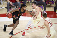 Maryland forward Donta Scott (24) drives against Wisconsin guards Trevor Anderson (12) and Brad Davison (34) during the first half of an NCAA college basketball game Wednesday, Jan. 27, 2021, in College Park, Md. (AP Photo/Nick Wass)