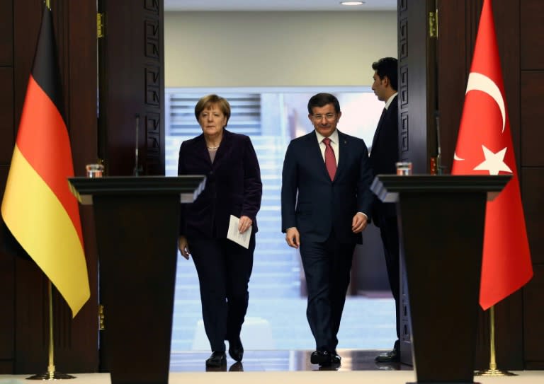 German Chancellor Angela Merkel and Turkish Prime Minister Ahmet Davutoglu ask NATO to help police on the Turkish coast to stop traffickers from sending migrants on dngerous journeys in a joint press conference on February 8, 2016