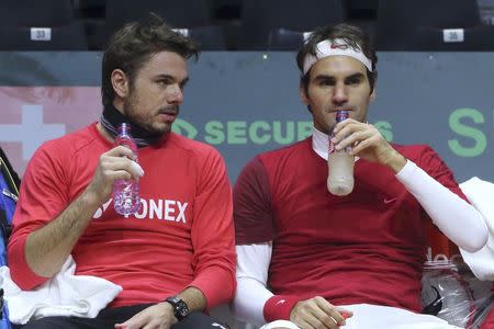 Roger Federer (R) and Stanislas Wawrinka of Switzerland attend a Davis Cup tennis training session at the Pierre Mauroy stadium in Villeneuve d'Ascq, northern France, November 20, 2014. REUTERS/Pascal Rossignol