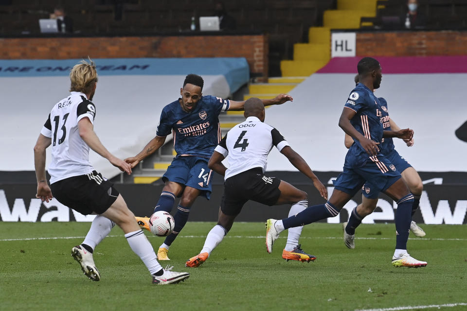 Arsenal's Pierre-Emerick Aubameyang, center, scores during the English Premier League soccer match between Fulham and Arsenal in London, Saturday, Sept. 12, 2020. (Ben Stansall/Pool via AP)