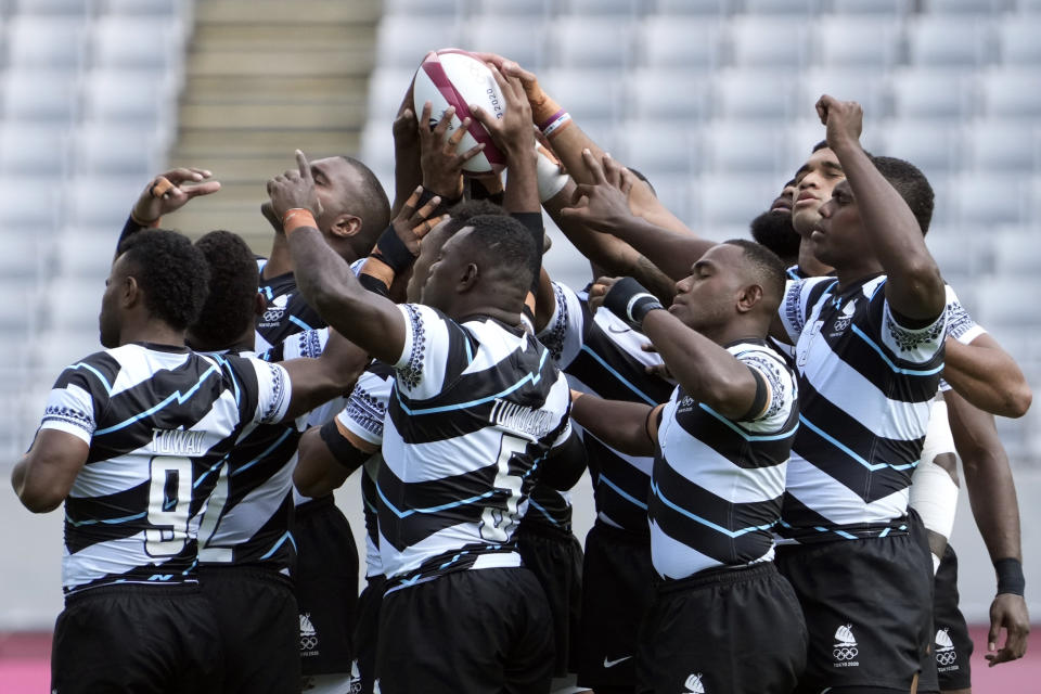 <p>Fiji team holds the ball before the start of their menâs rugby sevens match against Japan at the 2020 Summer Olympics, Monday, July 26, 2021 in Tokyo, Japan. (AP Photo/Shuji Kajiyama)</p> 