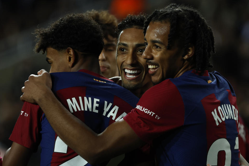 Barcelona's Raphinha, center, celebrates with his teammates after scoring his side's opening goal during a Spanish La Liga soccer match between Barcelona and Las Palmas at the Olimpic Lluis Companys stadium in Barcelona, Spain, Saturday, March 30, 2024. (AP Photo/Joan Monfort)